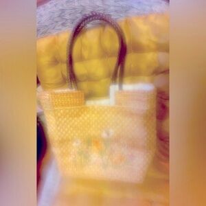 Purse with embroidered colorful flowers and braided brown straps